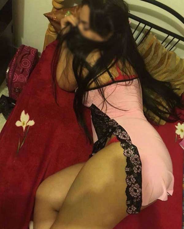 girl in pink nighty lying in bed with mask